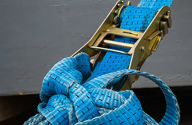 A close up of a blue ratchet strap