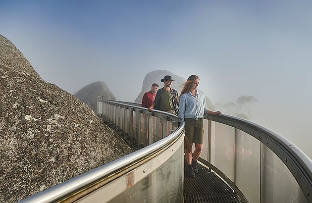 People standing on a skywalk platform at the Porongurup Range on a misty day