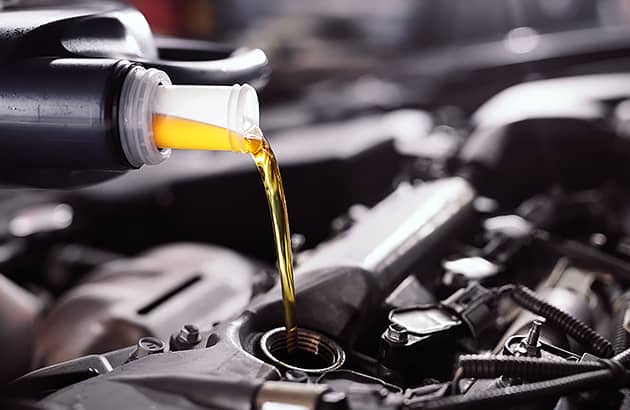 Pouring fresh oil into the car engine
