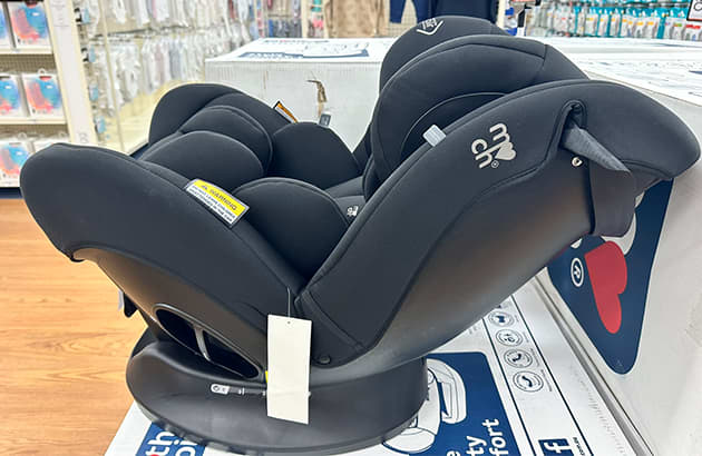 A rear facing child seat on the shelve in a store