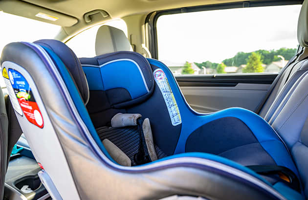 A rear facing child seat installed in a car
