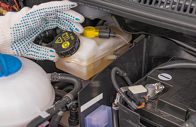 Unscrewing the cap on a brake fluid reservoir