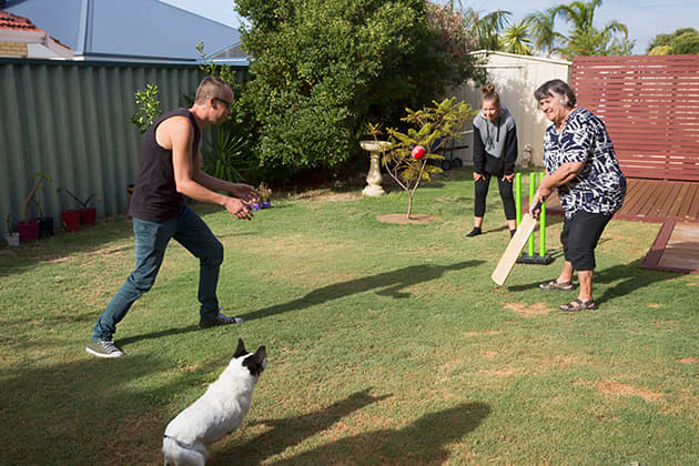 People playing backyard cricket