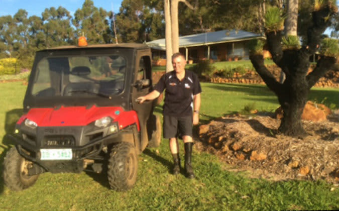 Crash victim Graeme Fry next to his tractor on the farm