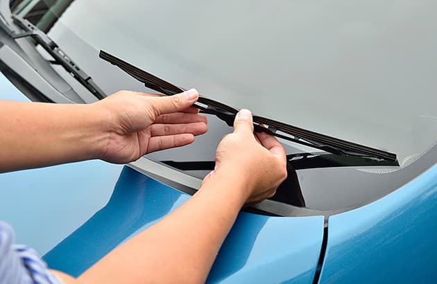 A person is checking the rubber on a windscreen wiper