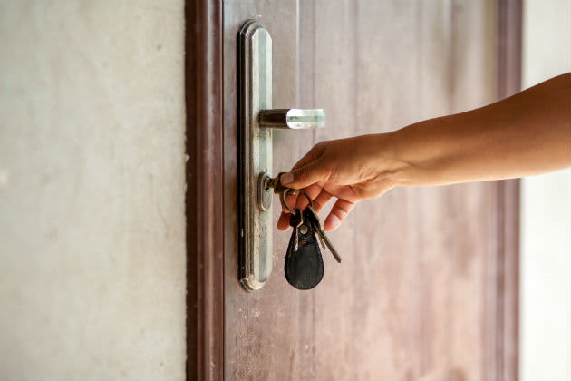 A woman locking a door