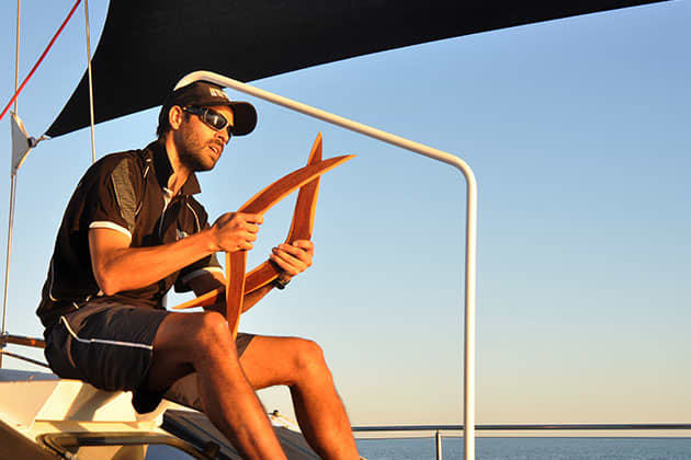 Bart Pigram showing guests boomerangs on his new eco cruise of Broome's Roebuck Bay