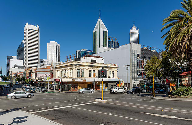 A car making a right-hand turn across traffic in the city