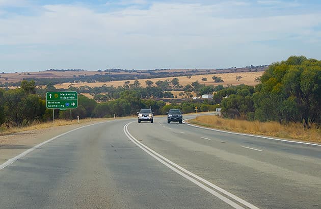 Two cars side by side on WA country road