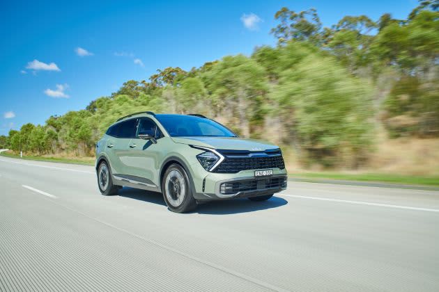 Green car driving on road