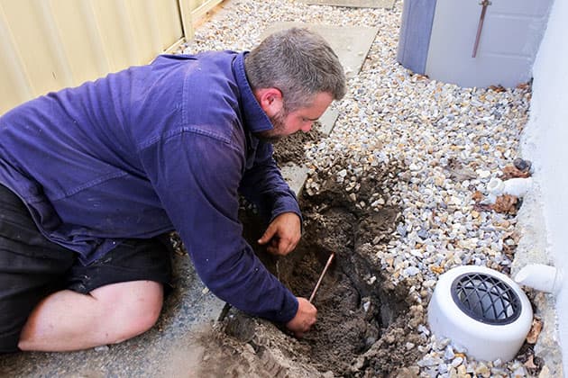 Plumber fixing copper pipe