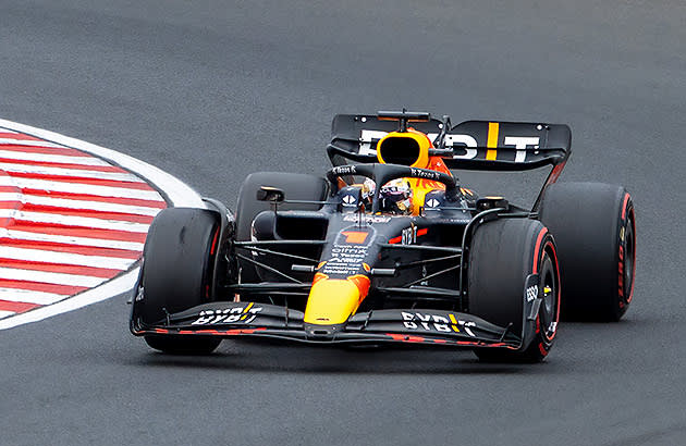 A black Formula 1 car on track seen from a front view
