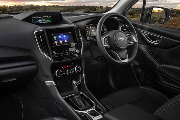 Inside a car showing centre console and steering wheel
