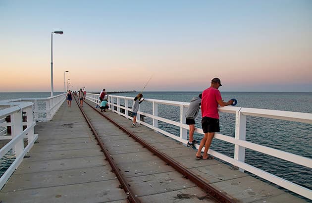 A father and son fishing from Busselton Jetty