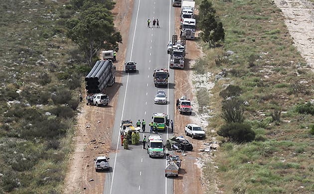 Police attend a truck crash on a WA regional road, where many emergency vehicles can be seen along a road.
