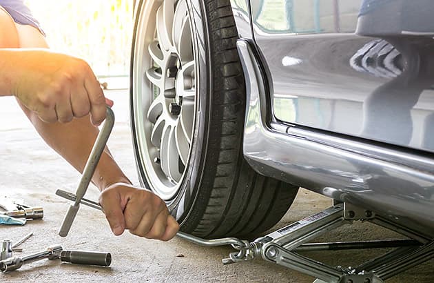 Raising a car with a jack