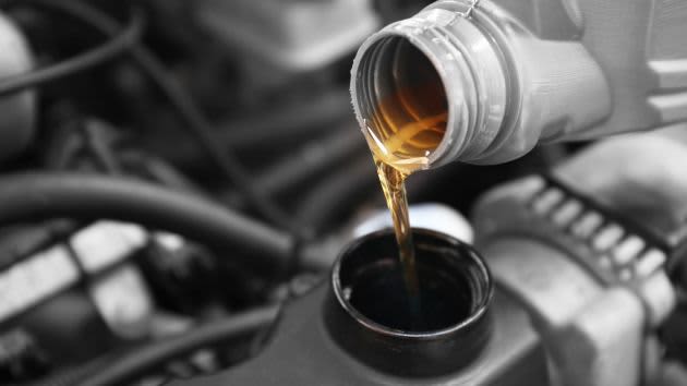 engine oil being poured into a car