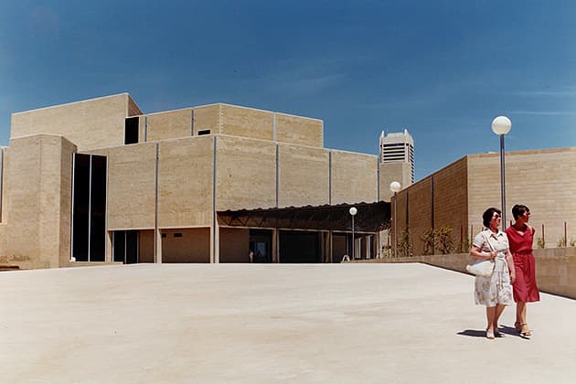 A historical photo showing two women walking in front of the WA Art Gallery in the 1970s.