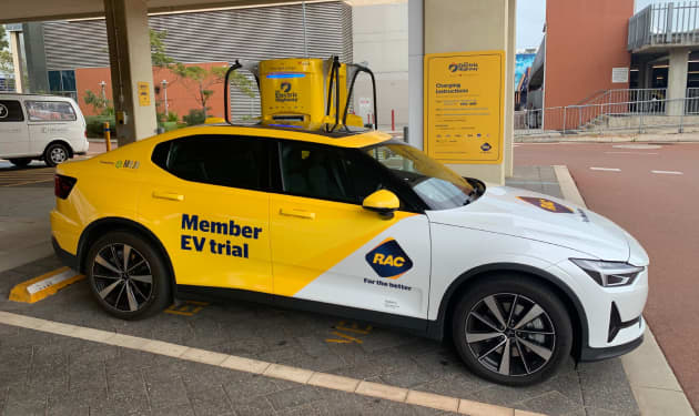 RAC branded yellow Polestar 2 electric vehicle parked at electric charging station