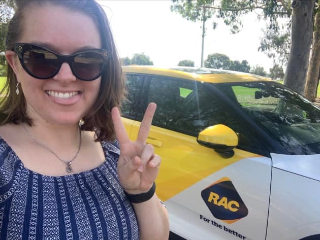 Selfie in front of RAC branded Polestar 2 electric vehicle