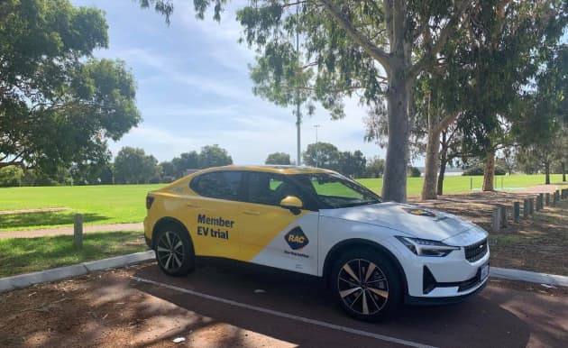 RAC branded Polestar 2 electric vehicle in parking bay beside a park