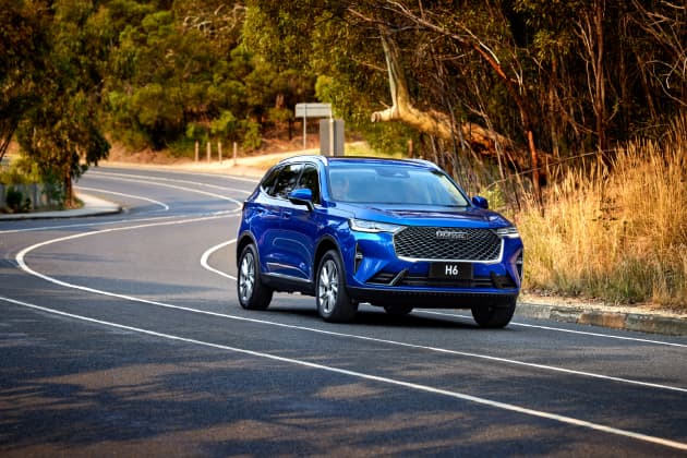 Blue Haval driving along road