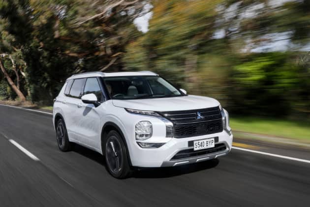White Mitsubishi driving on road
