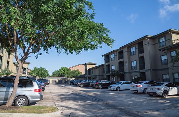 An apartment block with cars parked