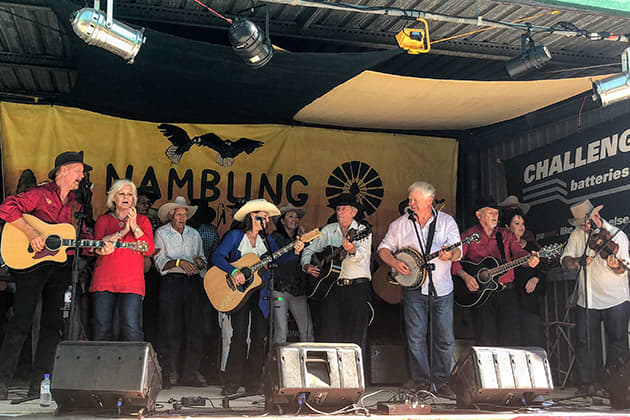 The stage is full of musicians performing together at the Nambung Country Music Muster
