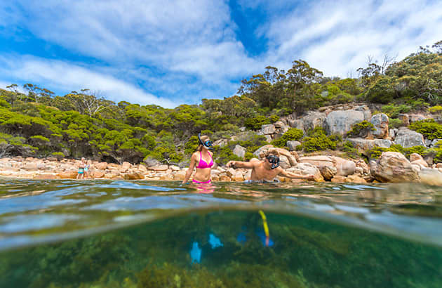 Two people swimming at Woody Island