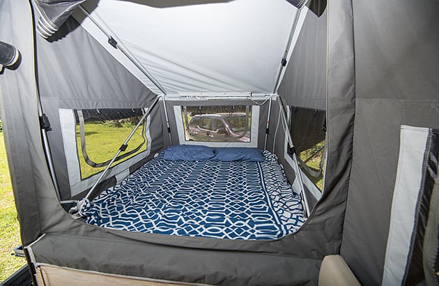A bed in a camper trailer