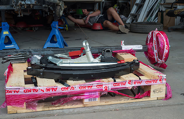 A worker assembling a trailer in a factory