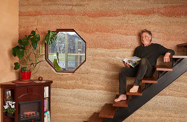 A man sitting on stairs inside a home