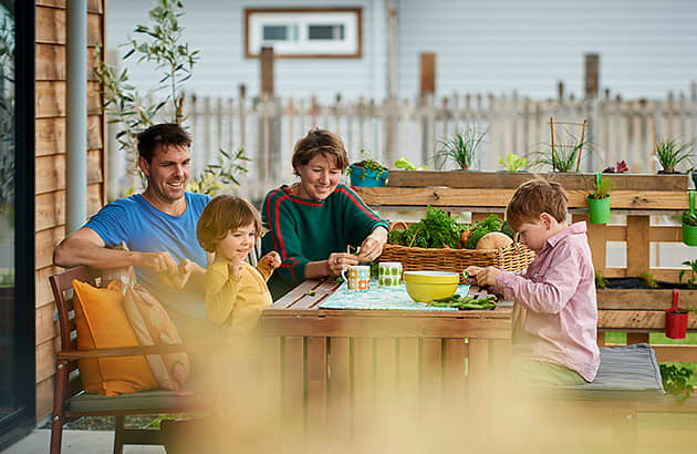 A family of four sitting at a kitchen table