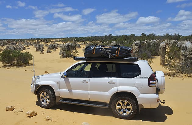 A Toyota Landcruiser driving on sand