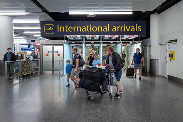 Travellers wearing masks in the airport