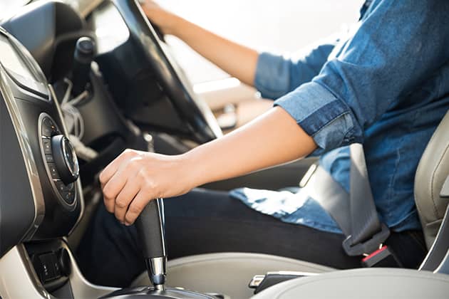 Image of woman with hand on gearshift