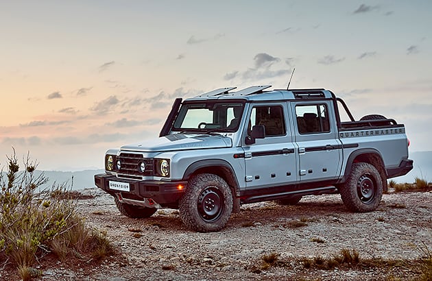 A light grey Ineos Grenadier Quartermaster parked in a rocky landscape