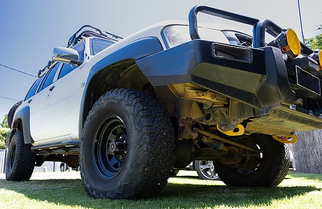 A four-wheel drive with a large bull bar and spotlights mounted to it