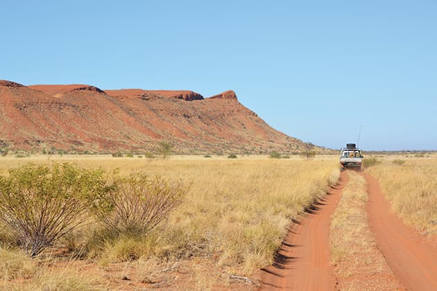 Car driving on long stretch of road