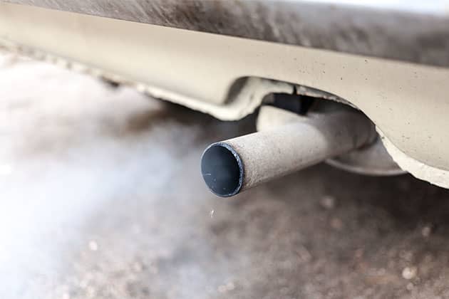 Smoke coming from a car exhaust pipe