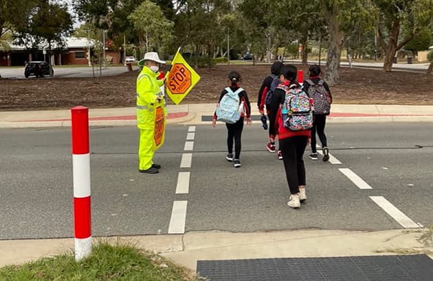 School children using a monitored children's crossing