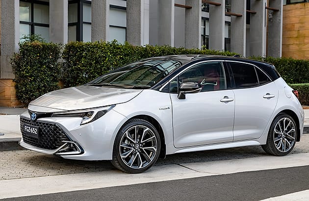 A white Toyota Corolla parked on a city street