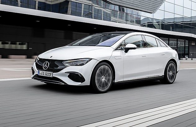 A white Mercedes Benz EQE parked on a city street