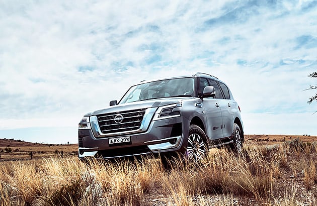 A silver Nissan Patrol on a dirt track