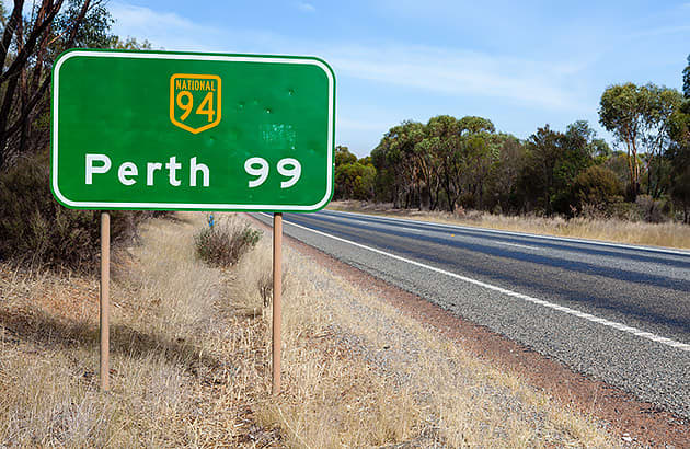 A road sign indicating the distance to perth as  99km