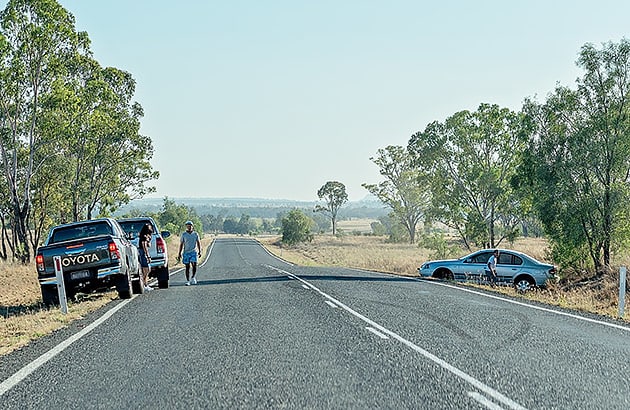 A crash involving three cars on a regional road seen in the distance