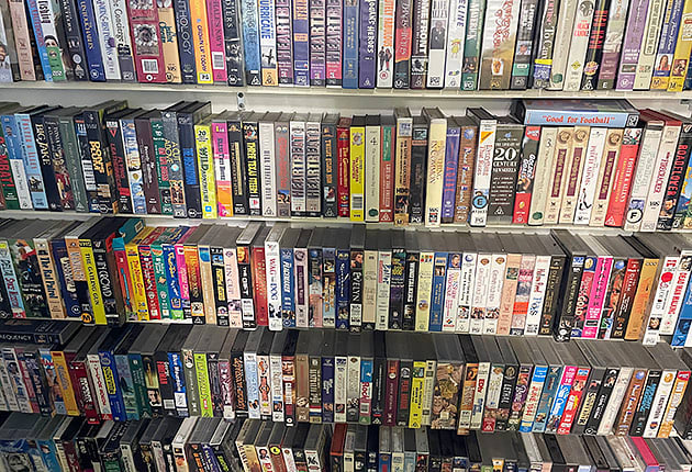 Shelves full of VHS tapes inside an op shop