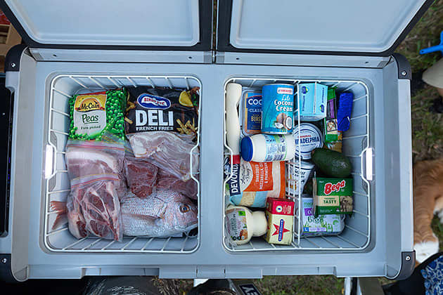A camping fridge stocked with food