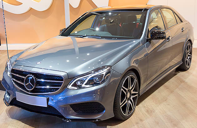 A blue Mercedes e400 in a car showroom
